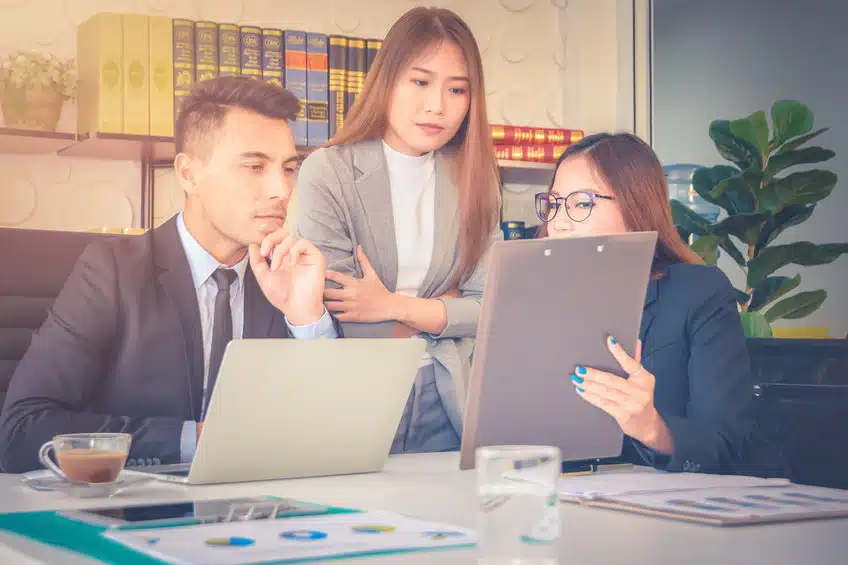 Financial report analysis and reviewing concept :CFO or chief financial officer sees financial summary reports with his secretary and discusses about future growth and improvements.
